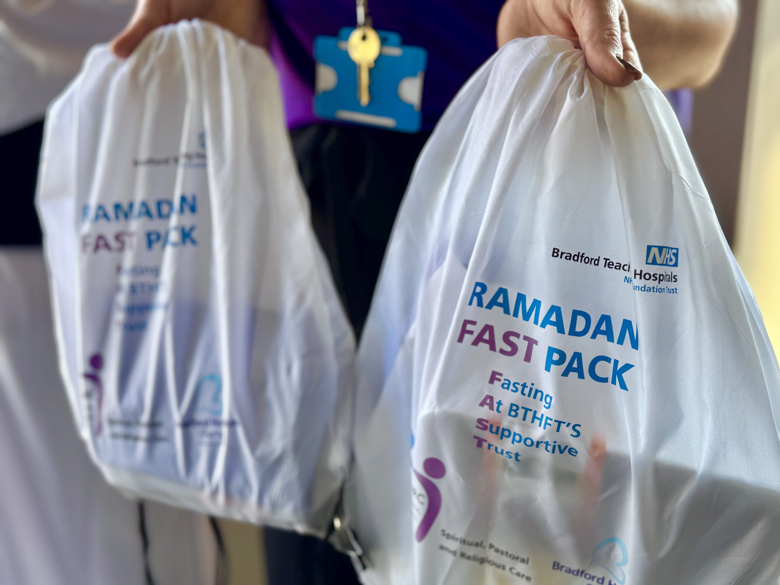 Charity team member holding two FAST pack bags.